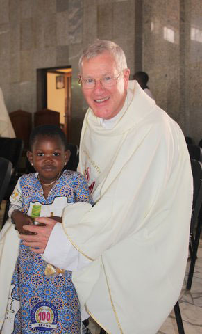 Fr-Corrigan-with-Child-afte